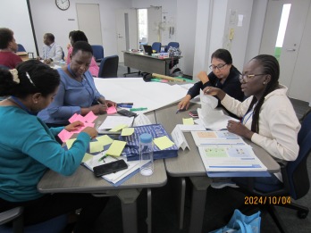 Participants sharing key takeaways from lectures and visits in a small group